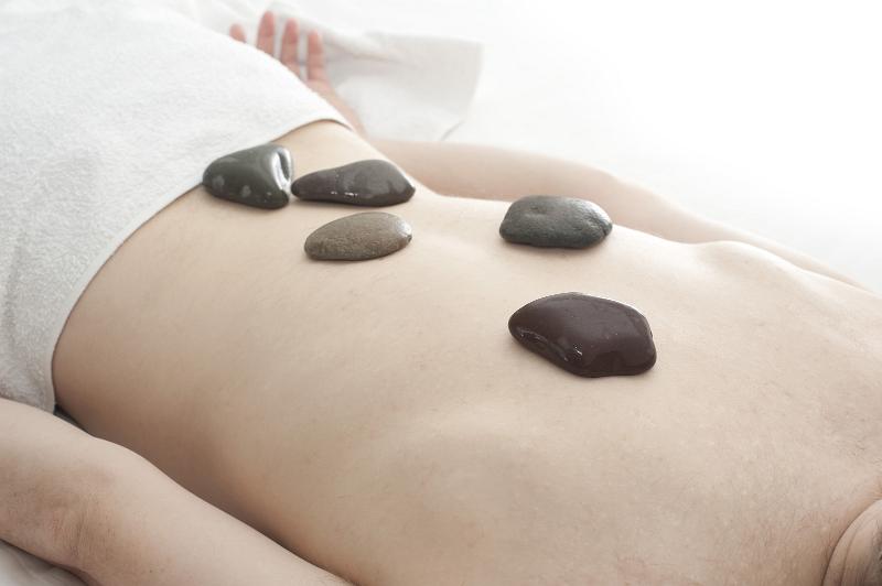 taking relaxing hot rock massage